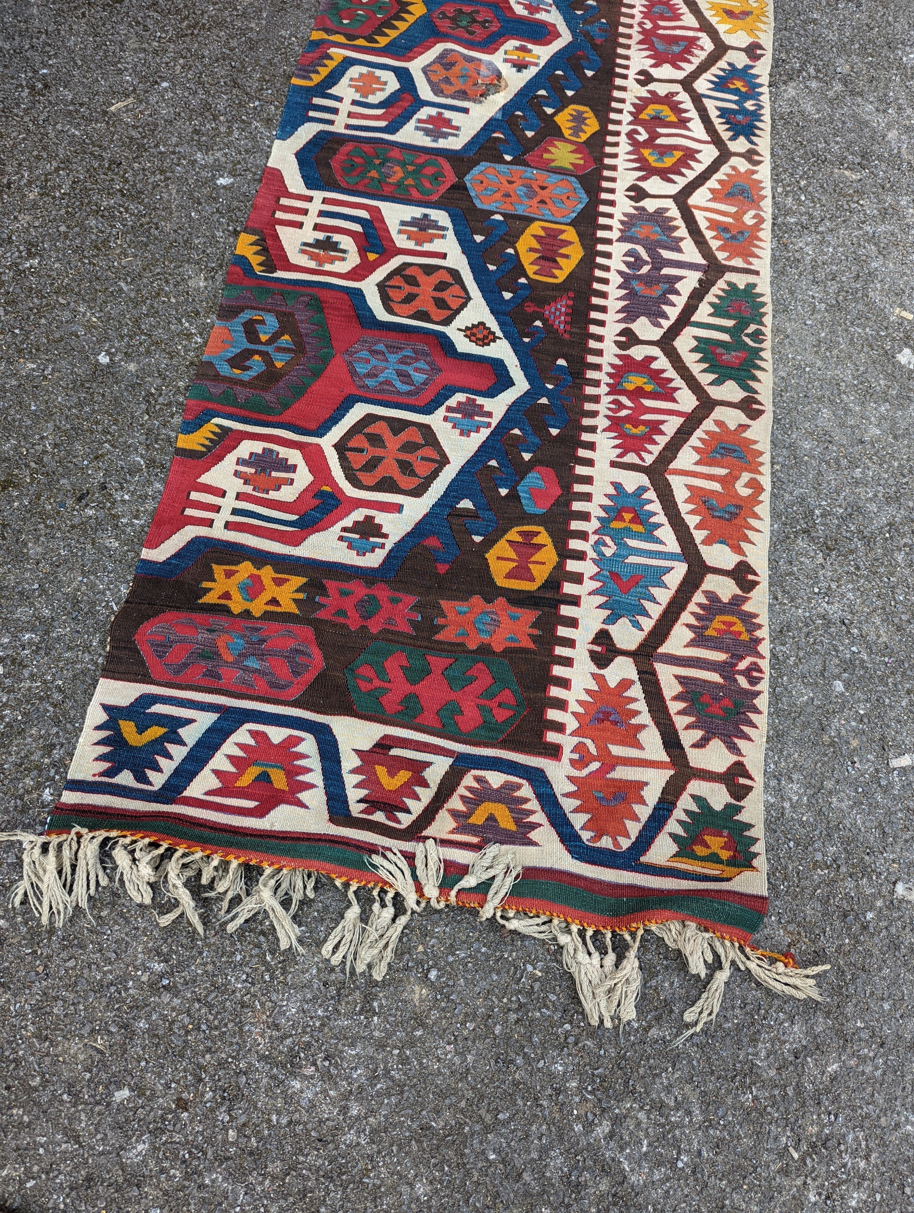 A large Kilim flatweave runner, 400 x 92cm (holed and cut)